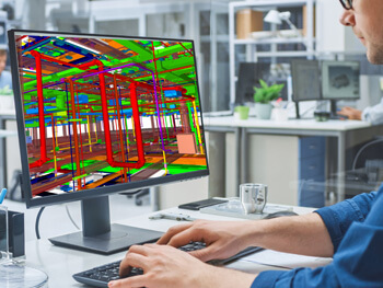 Engineering reviewing designs on a computer screen
