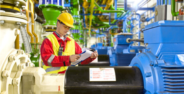 Field technician assessing equipment at a commercial facility