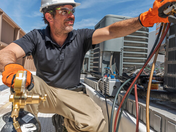 HVAC technician working on HVAC maintenance services